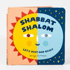 A square board book cover titled "SHABBAT SHALOM" with the subtitle "LET'S REST AND RESET" and the name "Suzy Ultman," featuring a split yellow-and-light-blue face, red sun rays, and small yellow stars on a dark blue half.