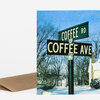 A folded greeting card with a matching brown envelope, featuring a street-sign image that reads "COFFEE RD" and "COFFEE AVE."