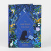 A hardcover book titled "The Little Witch's Book of Spells" with a blue illustrated cover featuring plants, flowers, butterflies, stars, a crescent moon, and a silhouette of a child holding a wand and open book.