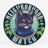 A round sign with a black cat illustration and the text "NEIGHBORHOOD WATCH" around the edge, with green vine-like leaves on both sides.
