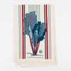 A cream-colored cloth with vertical red and blue stripes and a centered Swiss chard illustration, plus small printed text near the bottom.