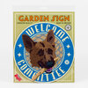 A circular garden sign with the words "WELCOME" and "COMMITTEE" around a German shepherd illustration, and "GARDEN SIGN" at the top.