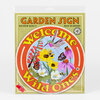 A packaged circular garden sign with the text "Welcome Wild Ones" and "GARDEN SIGN" around illustrations of a hummingbird, butterflies, bees, and flowers.