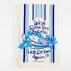 An off-white cloth with vertical blue stripes and a blue printed illustration and text reading "We’ve Done ’Em Before" and "We’ll Do ’Em Again."