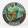 A round sign with the words "POLLINATOR FRIENDLY GARDEN" around an illustration of monarch butterflies and wildflowers.