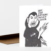 A folded greeting card with a black-and-white illustrated figure and the text "HOPE YOUR BIRTHDAY DOESN'T SUCK" on the front.