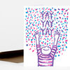 A folded greeting card shows a purple-and-pink illustrated person with raised arms beneath the repeated text "YAY YAY YAY" and confetti-like dots.