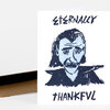 A folded white greeting card shows a stylized blue-and-black portrait of a vampire with the words "ETERNALLY" at the top and "THANKFUL" at the bottom.