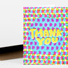A folded greeting card with a colorful abstract brushstroke pattern and the large yellow words "THANK YOU" on the front.