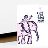 A folded greeting card with a pink-and-black illustration of a person riding an elephant and the text "LOVE YOU TONS MOM" with a small pink heart above it.
