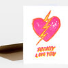 A folded greeting card with a pink broken heart pierced by a yellow lightning bolt and the text "TOTALLY LOVE YOU" on the front.