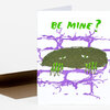 A folded greeting card with the text "BE MINE?" in green above a purple brick pattern and a dark green creature with eyes and clawed hands.
