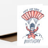 A folded birthday card with a cartoon skydiver and the text "HOPE YOU HAVE A TAROCLING BIRTHDAY."