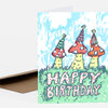 A folded greeting card shows three colorful mushrooms wearing party hats above the text "HAPPY BIRTHDAY."