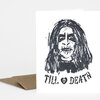 A white greeting card with a black hand-drawn portrait and the text "TILL ♥ DEATH" on the front, shown with a kraft paper envelope.