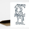 A folded greeting card with a black-and-white striped zebra illustration and the text "CONGRATS YOU GOT STRIPES" on the front.