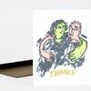 A folded greeting card with a loose illustrated drawing of two people hugging and the word "THANKS" printed in yellow on the front.