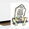 A folded greeting card shows a hand-drawn zombie crawling out of a tombstone labeled "HBD" and "NOT THIS YEAR".