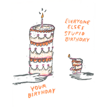 A folded birthday card with a hand-drawn tiered cake and candle illustration and the text "EVERYONE ELSE'S STUPID BIRTHDAY YOUR BIRTHDAY" on the front.