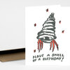 A folded greeting card with a cartoon hermit crab shell illustration and the text "HAVE A SHELL OF A BIRTHDAY!" on the front.
