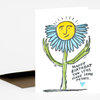 A folded greeting card with a hand-drawn smiling blue flower and the text "HAPPY BIRTHDAY YOU STILL HAVE SOME PETALS."