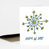 A folded greeting card with a blue and yellow abstract floral burst and the text "HOPE and JOY" on the front.