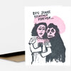 A folded greeting card with a black-and-pink illustration of two figures embracing and the text "LET'S SCROLL TOGETHER, FOREVER..." on the front.