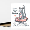 A greeting card with a hand-drawn mouse standing on a red spotted mushroom and the text "YOU MAKE ME SQUEAK" with a small heart.