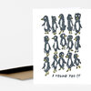 A folded white greeting card featuring a group of hand-drawn black penguins with yellow beaks and feet and the handwritten text "I FOUND YOU!!!" on the front.