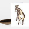 A folded greeting card with a stylized donkey illustration on the front and a plain matching envelope.