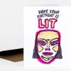 A folded birthday card with the text "HOPE YOUR BIRTHDAY IS LIT" above a bold illustrated face in black, beige, white, and bright pink.