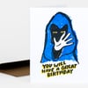 A folded birthday card with a blue-and-black illustrated cat-like figure and the text "YOU WILL HAVE A GREAT BIRTHDAY" on the front.