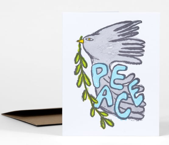 A greeting card featuring a gray dove carrying a green olive branch with the word "PEACE" in large blue letters.
