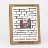 A kraft-paper card box set with a front label showing a black-and-white brick fireplace illustration with a small red Santa figure and the text "SIX LETTERPRESS PRINTED CARDS," "MERRIEST CHRISTMAS," and "W/ KRAFT ENVELOPES."
